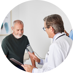 Man in blue shirt, wearing glasses, and talking on a cell phone